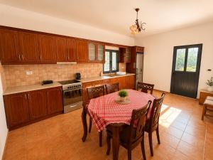 a kitchen with a table and chairs in a room at Villa Lions in Ksamil
