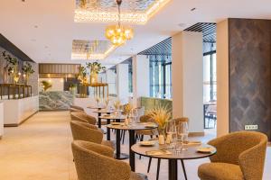 a dining room with tables and chairs at BIRGÉS HOTEL Lifestyle and View in Balatonfüred