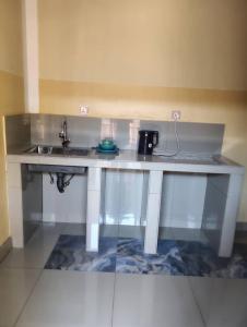 a kitchen with a sink and a counter top at Maisonnette KF Golf-Self Catering Apartments in Lubumbashi +15 photos