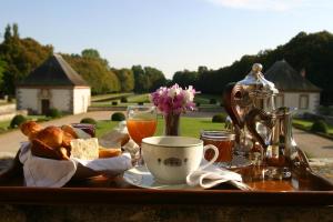 a tray of food with bread and a cup of coffee at Château-Hôtel de Bourron in Bourron-Marlotte