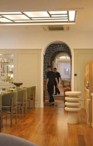 a man riding a skateboard in a room at Boutique Hôtel Le Clos Huguerie - Bordeaux Centre in Bordeaux