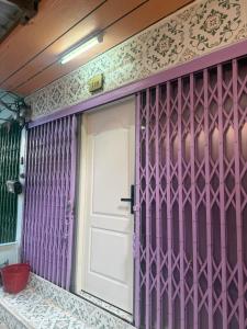 a purple front door of a house with a white door at best 148 train staytion in Godown +8 photos