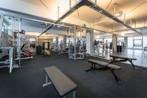 a gym with several benches and machines in a room at Hotel Reich Winterbach in Winterbach