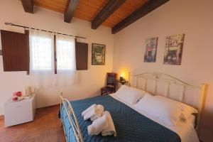 a bedroom with a bed with a stuffed animal on it at Cavagrande Guest House in Avola +36 photos