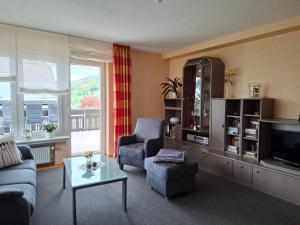 a living room with a couch and a tv at Ferienwohnung Waltraud in Brilon