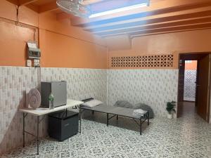 a room with a bed and a table in a room at best 148 train staytion in Godown
