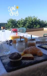 a table with some food and jars of honey at B&B MiraValle in Scanzorosciate