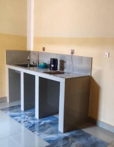 a kitchen with a counter top with a sink at Maisonnette KF Golf-Self Catering Apartments in Lubumbashi