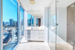 a bathroom with a shower and a view of the city at Luxurious 2 Bedroom Apartment - Ocean View in Gold Coast +11 photos