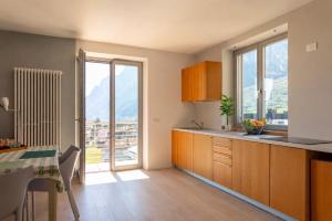 a kitchen with a table and a view of mountains at View & Chill Apartment in Riva del Garda