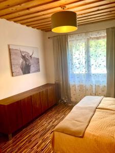 a bedroom with a bed and a picture of a bull on the wall at Ferienwohnung Oberprossegg in Matrei in Osttirol
