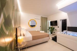 a bedroom with a bed and a mirror and a tub at Tortugas B&B in Giarre