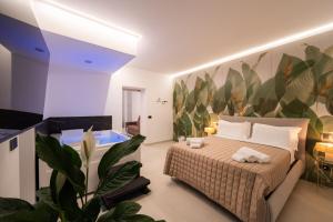 a bedroom with a large bed and a bath tub at Tortugas B&B in Giarre