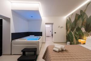 a bedroom with a sink and a bed and a tub at Tortugas B&B in Giarre +45 photos