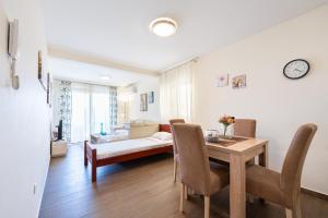 a living room with a table and a dining room at Apartments Horizont in Budva +78 photos