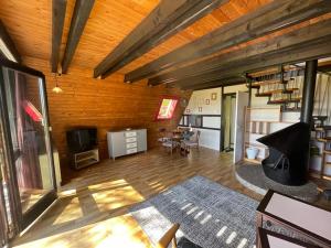 a living room with wooden walls and a wooden floor at Feriendorf Sulzfeld in Sulzfeld