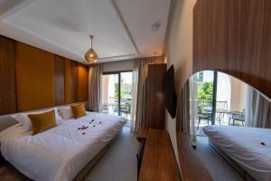 a bedroom with two beds and a balcony at Riad Yacout in Meknès +225 photos