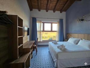 a hotel room with a bed and a window at Agriturismo Maison Oro Verde in Verona