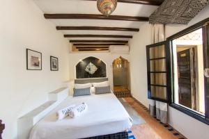 a bedroom with a large white bed in a room at Riad Yacout in Meknès