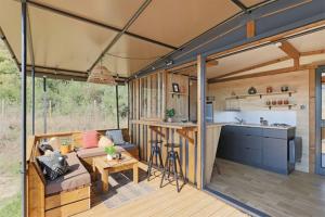 a living room and kitchen of a tiny house at Camping du Lac de Cazaux in La Teste-de-Buch