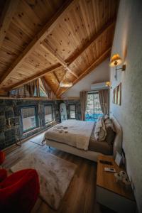 a bedroom with a large bed and wooden ceilings at Sky Line Villa in Ardeşen