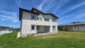 a house on a hill with a grassy field at منتجع سراييفو - Sarajevo Resort in Sarajevo