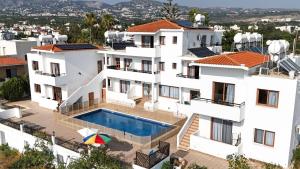 an aerial view of a house with a swimming pool at Sunset Sea View Retreat with pool in Kissonerga