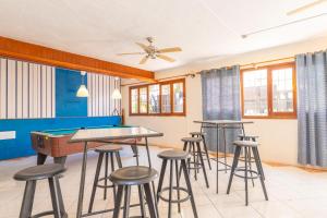 a room with a pool table and stools at Hotel Antares in Cala d´Or