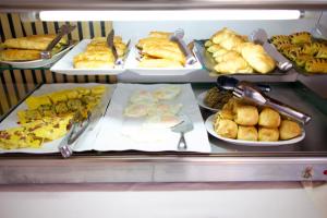 a buffet filled with different types of food on plates at SANIMAR By Mono Alex in Kassandra