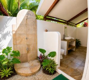 an outdoor bathroom with a toilet and a sink at Jala Villas Lances Right HTs Mentawai in Katiet +54 photos