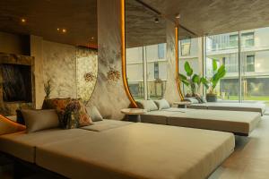 a room with three beds and a couch and windows at BIRGÉS HOTEL Lifestyle and View in Balatonfüred +52 photos