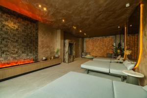 a living room with a couch and a fireplace at BIRGÉS HOTEL Lifestyle and View in Balatonfüred