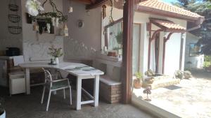 a table and chair in a room with a window at Villa Toni in Varna City