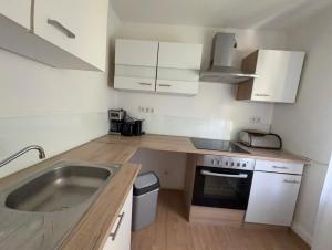 a small kitchen with a sink and a stove at Zentral in Siegen +8 photos