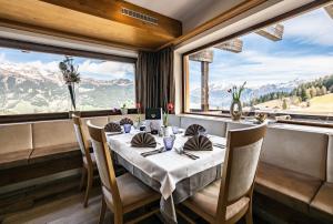 a table in a restaurant with a view of mountains at Sporthotel Kalcherhof in Racines +56 photos
