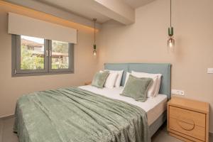 a bedroom with a bed with a green blanket and a window at Sea View in Laganas +51 photos