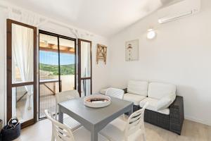 a living room with a table and a couch at Sabbiamare Torre dei Corsari in Torre Dei Corsari