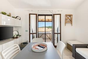 a living room with a table with a bowl of food on it at Sabbiamare Torre dei Corsari in Torre Dei Corsari