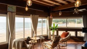 a living room with a view of the beach at Beach apartment - Ocean sunset full view in Meschers-sur-Gironde