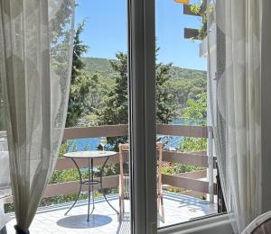 a room with a view of the ocean from a balcony at Molat Bay View in Molat