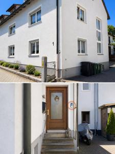 a white house with a wooden door and a street at Monteur-Ferienwohnung Julianna in Bad Staffelstein in Bad Staffelstein