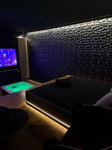 a room with a bed and a tv in a room at MIRAGE47SPA - Private Spa Suite with Jacuzzi & Sauna in Marbella in Marbella