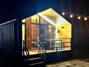 a tiny house with a porch and a staircase at Tosor Barnhouse in Tossor