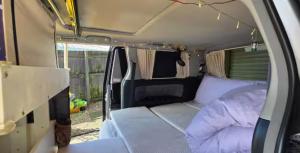 an inside of a van with a bed in it at Campvan Stay in Auckland