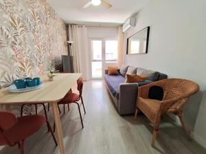 a living room with a couch and a table at Apartamento Puerta de Madrid 1 in Alcalá de Henares