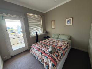 a bedroom with a bed and a window at Darling Point with Harbour Views in Sydney