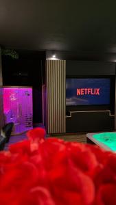 a room with a television and a netflix sign at MIRAGE47SPA - Private Spa Suite with Jacuzzi & Sauna in Marbella in Marbella