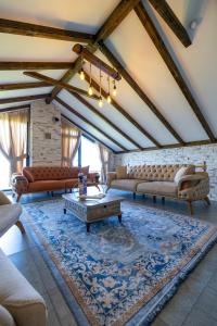a large living room with couches and a table at Poison Garden Suite & SPA in Gözalan