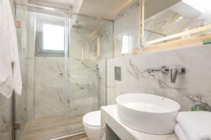 a bathroom with a shower and a sink and a toilet at Sea View in Laganas