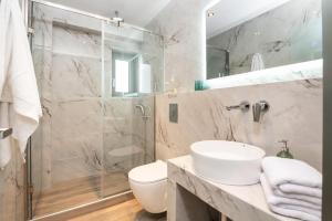 a bathroom with a shower and a sink and a toilet at Sea View in Laganas